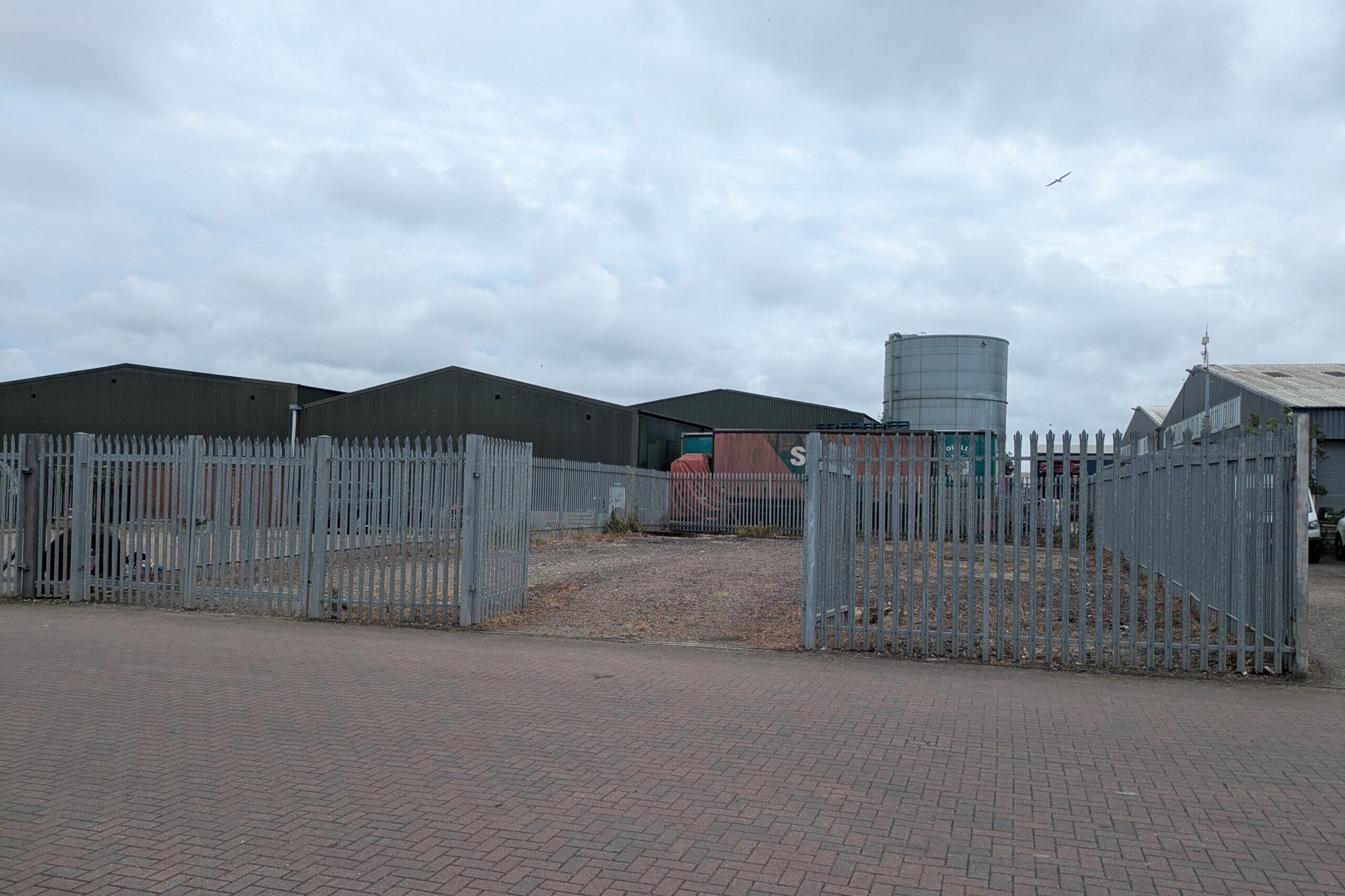 Photograph of empty, surfaced yard taken from outside the yard showing the right hand set of access gates