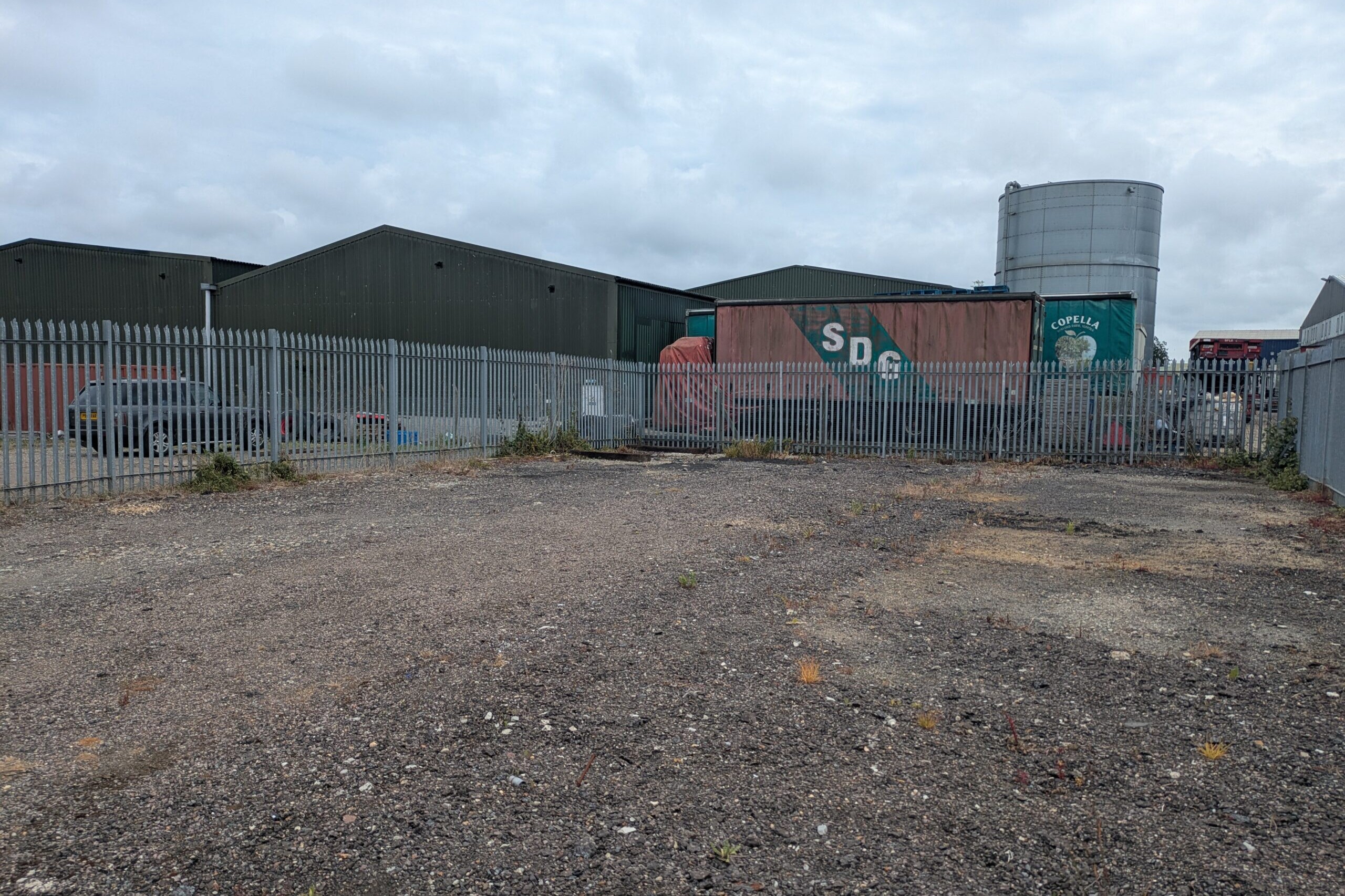Photograph of empty, surfaced yard taken from North-West corner