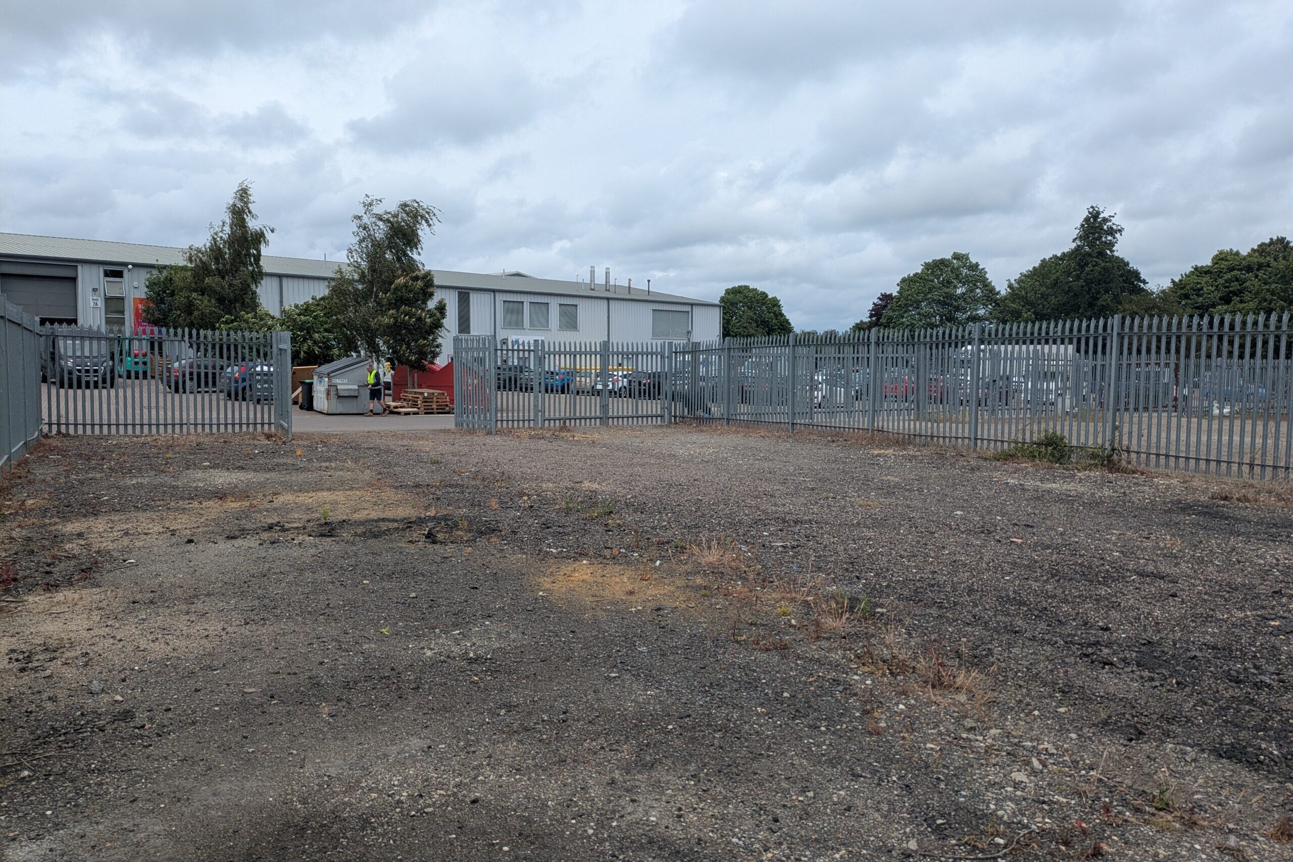 Photograph of empty, surfaced yard taken from South-West corner