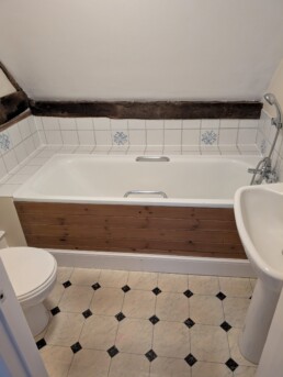 Bathroom including bath, sink and toilet